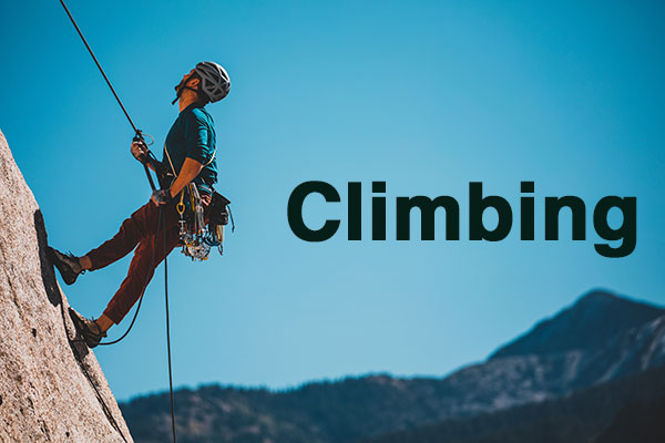 man climbing mountain